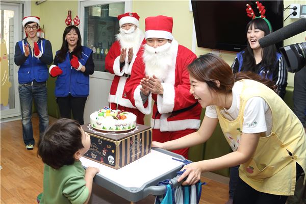 삼성물산 직원들이 산타복장을 하고 아이들과 함께 기쁘게 웃고 있다. 사진=삼성물산 제공