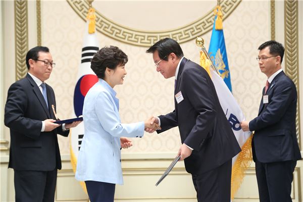 1일 오후 청와대 영빈관에서 개최된 ‘2014 대한민국 중소기업인대회’ 및 ‘중소기업유공자 포상 수여식’에서 박근혜 대통령이 김한조 외환은행장에게 ‘중소기업유공자 지원우수단체 부문 대통령표창’을 수여 후 악수를 나누고 있다. 사진=외환은행 제공