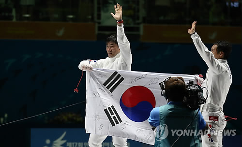 20일 오후 고양체육관에서 열린 제17회 인천아시아경기대회 펜싱 남자 에뻬 결승에서 금메달과 은메달을 나눠 가진 정진선(왼쪽)과 박경두(해남군청)가 태극기를 들고 함께 기쁨을 나누고 있다. 사진=연합뉴스