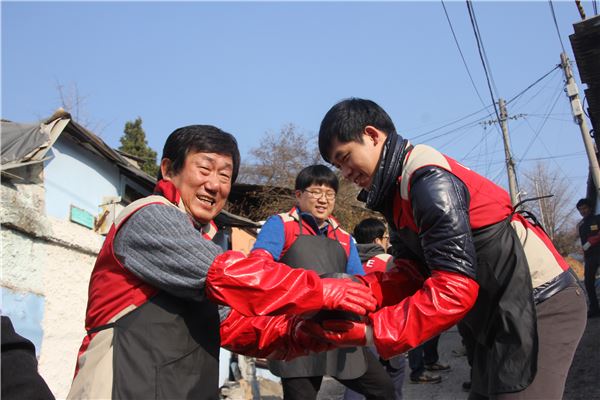 김치현 롯데건설 대표이사(왼쪽)가 임직원과 함께 연탄나눔 봉사활동을 하고 있다. 사진=롯데건설 제공