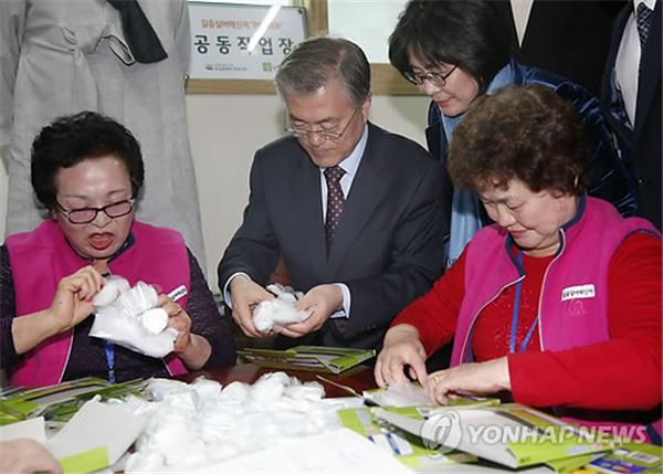 문재인 새정치민주연합 대표가 24일 서울 성북구 생활지원센터를 찾아 공동작업장에서 1회용 비닐장갑 포장을 하고 있다. 사진=연합뉴스 제공