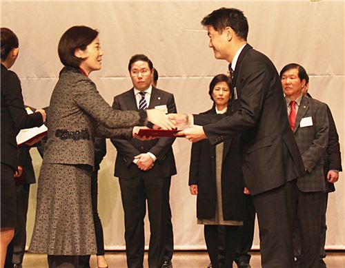 나카무라 히데오 SBI저축은행 대표이사가(사진 오른쪽) 김희정 여성가족부 장관으로부터 가족친화우수기업 인증서를 받고 있다. 사진=SBI저축은행 제공.