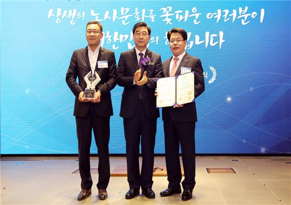 손교덕 경남은행 은행장(사진 오른쪽)과 김병욱 노조위원장(사진 왼쪽)이 2015 노사문화 유공 정부포상 시상식에 참석해 이기권 고용노동부장관으로부터 ‘국무총리상’을 받고 있다. 사진=경남은행 제공