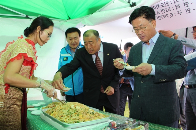 강인규 시장과 김판근 시의회의장이 음식을 시식하고 있다.