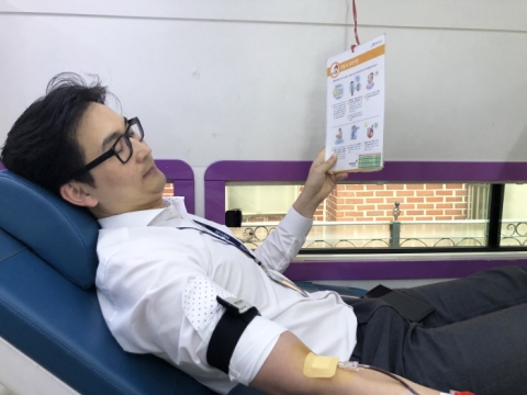 헌혈 후 유의사항을 읽고 있는 현대유비스병원 전도현 총무팀장.