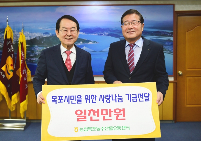 농협목포유통센터 김동기 사장(오른쪽)이 김종식 목포시장(왼쪽)에게 “사랑 나눔 기금” 일천만원을 전달하고 있다.