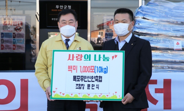 김산(왼쪽) 군수가 문만식 축협 조합장으로부터 백미 1,000포를 기탁받고 기념촬영을 하고 있다.