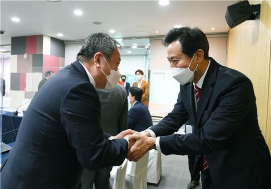 14일 김인호 서울시의회 의장(왼쪽)이 오세훈 서울시장과 만나 악수를 나누고 있다.