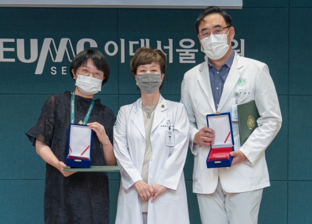(왼쪽부터)신윤희 간호사, 유경하 이화의료원장, 주웅 교수가 기념사진을 찍고 있다