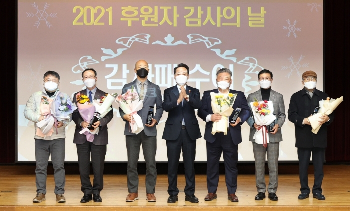 한국마사회 광주지사 정지련 지사장(왼쪽 두번째)이 ‘2021년 후원자 감사의 날’에 임택 동구청장(오른쪽 네번째)으로부터 감사패를 수여 받고 수상자들과 기념촬영 모습