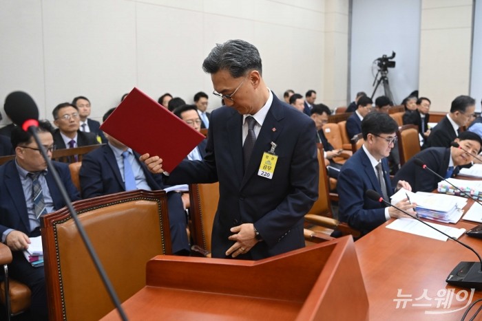 고정욱 롯데지주 사장이 13일 오후 서울 여의도 국회 기획재정위원회에서 열린 기획재정부(경제·재정정책)에 대한 2025년도 국정감사에 증인으로 출석해 증인선서문을 들고 발언대로 향하고 있다. 사진=강민석 기자 kms@newsway.co.kr