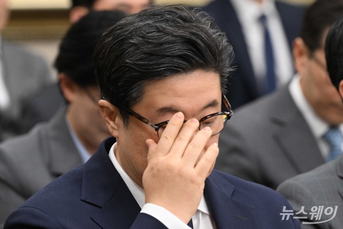 김병주 MBK파트너스 회장이 14일 오후 서울 여의도 국회 정무위원회에서 열린 공정거래위원회-개인정보보호위원회-소비자원 등에 대한 2025년도 국정감사에 증인으로 출석해 안경을 고쳐 쓰고 있다. 사진=강민석 기자 kms@newsway.co.kr