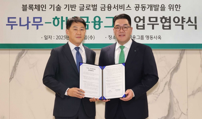 두나무는 지난 3일 하나금융그룹과 블록체인 기술을 활용한 금융서비스 공동 개발을 위한 업무협약을 체결했다. 이날 협약식에 참석한 오경석 두나무 대표(사진 왼쪽)와 이은형 하나금융그룹 부회장(사진 오른쪽)이 함께 협약서를 들고 기념촬영을 하고 있다. 사진=하나금융그룹 제공