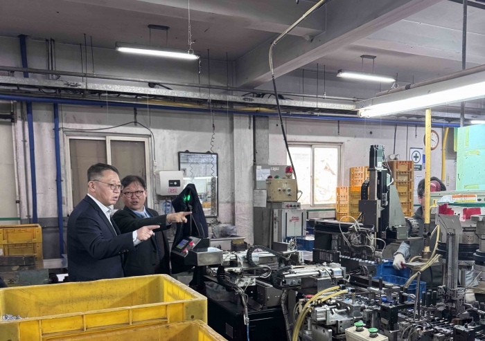 우리은행 정진완 은행장(왼쪽)이 국내 중소기업을 방문해 생산 현장에 대해 관계자로부터 설명을 듣고 있다. 사진=우리은행 제공